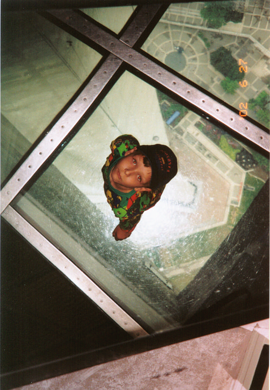 13. CN tower main deck -- Andrew on glass floor.png